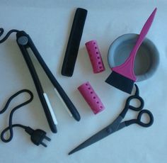 scissors, combs, and other crafting supplies laid out on a white surface