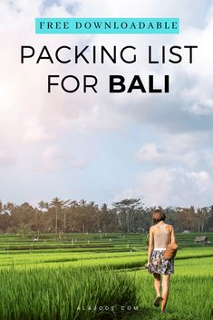 a person walking through a field with the words packing list for bali in front of them