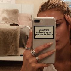 a woman holding up her phone to take a selfie with the text social media seriously harms you mental health