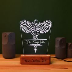 an illuminated medical symbol on a wooden stand