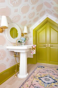 a bathroom with a sink, mirror and rug in it