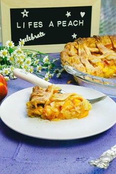 a piece of pie sitting on top of a white plate next to a blue table cloth