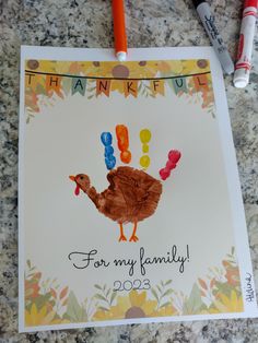 a thanksgiving card with a handprint turkey on it