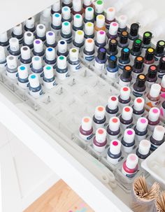 an assortment of different colored inks on a tray