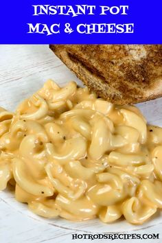 instant pot macaroni and cheese on a plate next to a piece of bread