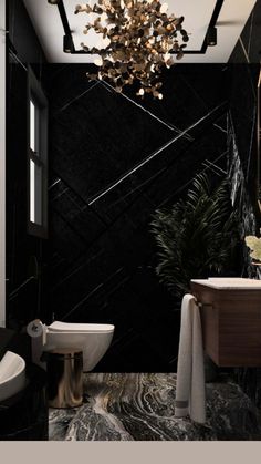 a black and white bathroom with a chandelier hanging from the ceiling over the toilet