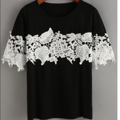 a black shirt with white lace on it