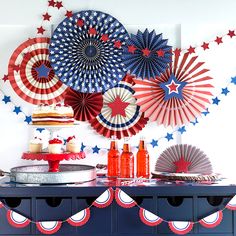 an american themed party with red, white and blue decorations on the wall above it