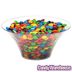 a glass bowl filled with lots of colorful candy