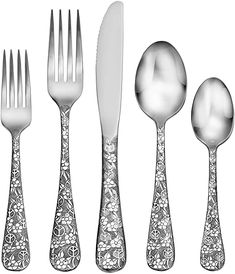 an assortment of silverware including forks, knives and spoons with floral designs on them