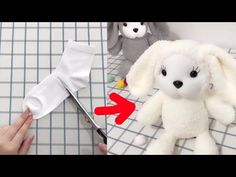 someone is cutting the fabric off of a stuffed animal with scissors and other things to make it look like they are holding something