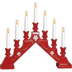 a red candle holder with white candles in it