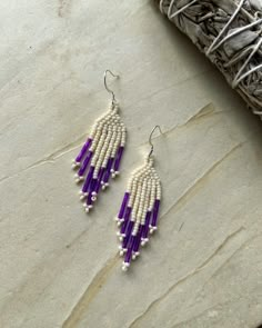 These earrings are a small length. Made with Miyuki beads. They are approximately 6cm in length & have a Silver-Plated hypoallergenic ear wire. Adjustable Long Drop Beaded Earrings With Dangling Beads, Purple Dangle Earrings With Tiny Beads, Long Drop Beaded Earrings, Purple Adjustable Earrings With Tiny Beads, Adjustable Purple Earrings With Tiny Beads, White Beaded Teardrop Crystal Earrings, Purple Beaded Long Drop Earrings, Adjustable White Linear Earrings, Purple Fringe