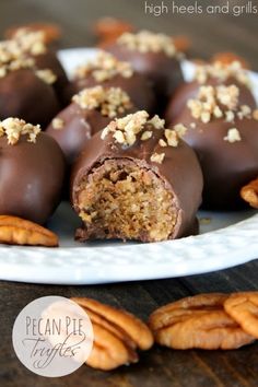 chocolate covered candies on a plate with pecans