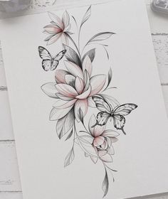 a drawing of flowers and butterflies on paper with watercolor pencils next to it