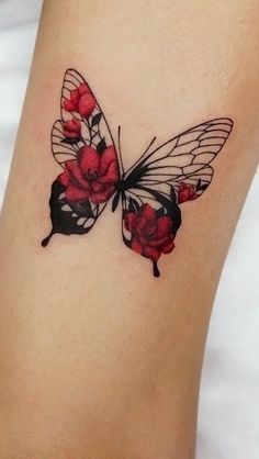 a small butterfly tattoo with red flowers on it's back side leg and wings