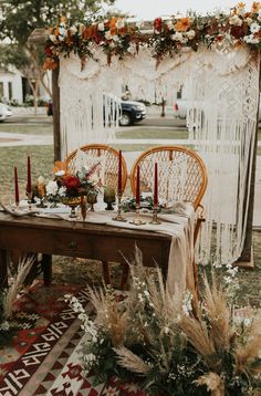 a table set up with flowers and candles