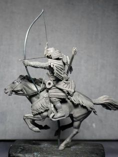 a statue of a man on a horse with a bow and arrow in his hand