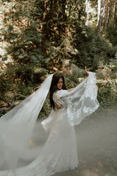 a woman in a white dress is holding her veil over her head and she has the words, adventures oregon elopements written on it