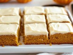 a white plate topped with slices of pumpkin cake next to small oranges on a table