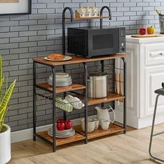 a microwave oven sitting on top of a wooden shelf