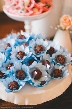 there is a cake with blue flowers on the top and chocolates in the middle