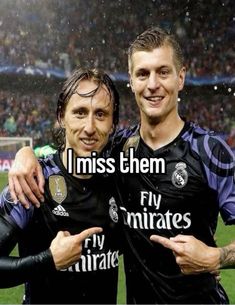 two men standing next to each other in front of a soccer field with the words i miss them