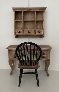 a wooden desk with a chair next to it and a book shelf above the desk