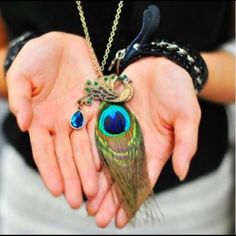 Peacock Feather Pendant Necklace Add a touch of exotic style to your everyday look with this peacock eye feather necklace. Great accessory and a unique gift.                                                                           Each feather is one-of-a-kind, so all feathers will vary slightly in color, size and shape.                                                              Length: 32”                                                        Add to Cart :) Jewelry Necklaces قلادات متدلية, Peacock Jewelry, Feather Pendant Necklace, Peacock Necklace, Peacock Pendant, Discount Jewelry, Long Chain Necklace, Feather Pendant, Long Pendant Necklace