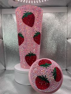 two pink vases with strawberries on them