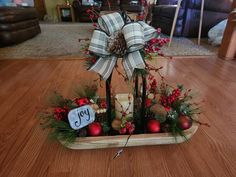 a basket filled with christmas decorations on top of a wooden floor