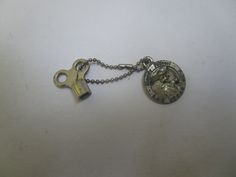 a keychain with a compass on it and a chain