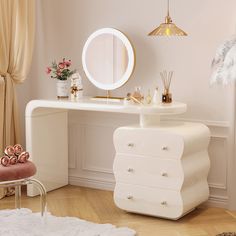 a white dressing table with a mirror and stool