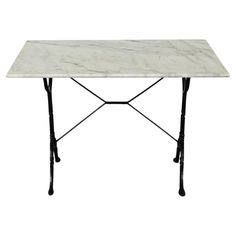 a white marble table with black legs and a metal frame on an isolated white background