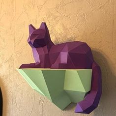 an origami cat sitting on top of a shelf