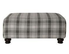 a grey and white checkered ottoman with wooden legs