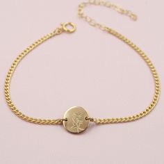 Our Birthflower Disc Bracelet features a tiny engraved disc with the birthflower of your choice hanging along a sturdy curb chain. Finished with a spring ring clasp and extender, making it easy to wear and adjust for the perfect fit.DETAILS- 14kt gold filled or sterling silver- 6" long with a 2" extender- Can be worn 6-8 inches- Choose one birthflower for engraving January: CarnationFebruary: VioletMarch: Cherry BlossomApril: DaisyMay: LilyJune: RoseJuly: LotusAugust: PoppySeptember: AsterOctobe Adjustable Everyday Jewelry With Birth Flower, Dainty Engraved Adjustable Charm Bracelet, Minimalist Adjustable Jewelry With Flower Charm, Minimalist Adjustable Flower Charm Jewelry, Dainty Adjustable Engraved Chain Bracelet, Dainty Engraved Adjustable Chain Bracelet, Dainty Engraved Charm Bracelet, Adjustable Engraved Dainty Chain Bracelet, Adjustable Engraved Round Disc Bracelet