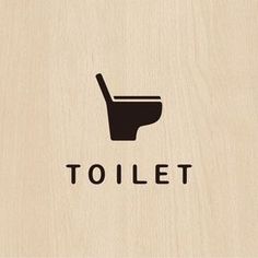 a wooden sign with the word toilet on it's side and a hand holding a plunger