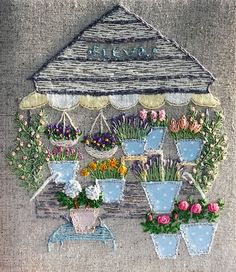 an embroidered picture of flowers and potted plants