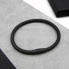 Refresh your look with our men's slim leather black clasp bracelet, handcrafted for a perfect balance of style and versatility. Available in a choice of single or double strand designs, this bracelet is made from premium woven leather and gives you the option of either a sleek, minimalist vibe or a layered, bold appearance. It's the go-to accessory for any occasion, effortlessly elevating any outfit. Available in four classic leather colours, black, dark brown, navy, and grey, this bracelet is designed to suit every taste and wardrobe. The sleek black matt clasp adds a modern, masculine touch while ensuring durability. With two wrist size options, 19cm or 21cm, it offers a comfortable, tailored fit for everyday wear. Searching for the perfect stocking filler or Secret Santa gift this Chris 3rd Wedding Anniversary, Minimalist Vibe, Jewelry Mens, Gift Bracelet, Clasp Bracelet, Bracelet Men, Secret Santa Gift, Mens Leather Bracelet, Black Gift Boxes