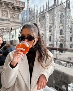 a woman holding a wine glass in front of her face