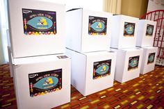 four white refrigerators sitting on top of a carpeted floor