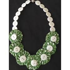 a green and white necklace with buttons on it