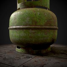 an old green tank sitting on top of a cement floor