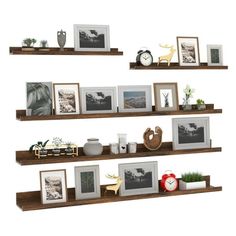 three wooden shelves with pictures and frames on them