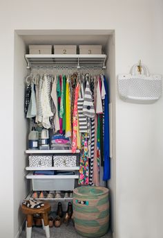 an organized closet with clothes, shoes and other items on shelves next to a laundry basket