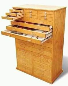 a large wooden dresser with drawers on it's top and bottom drawer open to show the contents