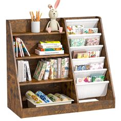 a wooden book shelf with books and toys on it, including a stuffed bunny sitting on top