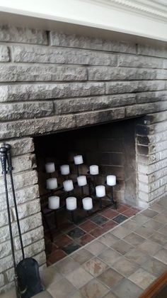 a fire place with candles on the mantle