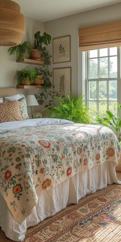 a bed sitting in a bedroom next to a window with potted plants on it